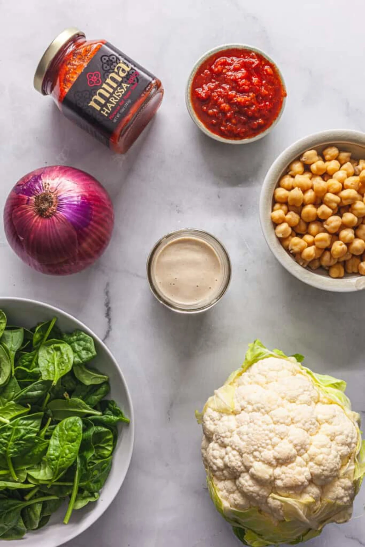 Harissa Roasted Cauliflower and Chickpeas with Tahini Sauce 
